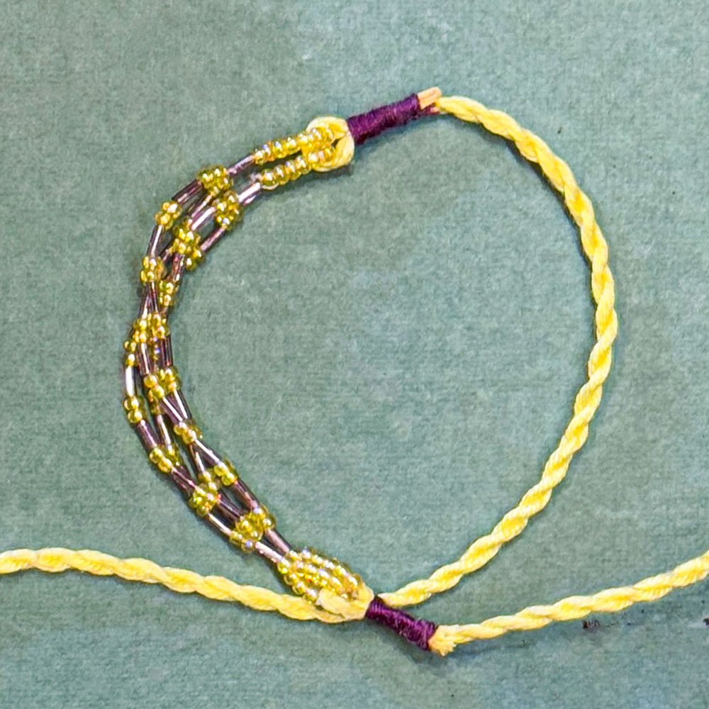 Handmade Reusable Yellow Corel And Jhumki Rakhi For Brother - Close-up of Knot and Beadwork