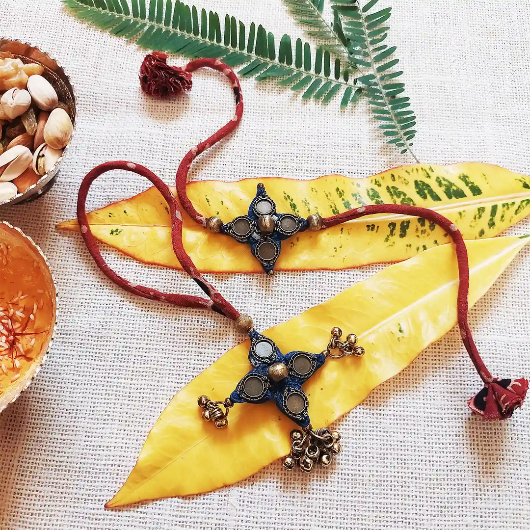 Handmade Dori Work And Ghungroo Bhaiya Bhabhi Rakhi With Roli Chawal Set Of 2 - Styled with Leaves and Nuts