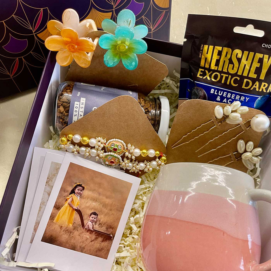 Photo Personalized Handmade Threads And Treasures Rakhi Hamper Includes 1 Mug 2 Clips 5 Photos 3 Hair Pin 1 Marble Lotus 1 Chocolate 1 Coffee And 1 Set Rakhi - Close-up of Gift Box Contents