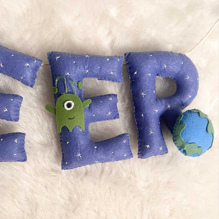 Handcrafted Personalized Space Themed Bunting For Kids - Close-up on Letter Pillows Arrangement