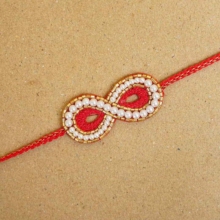 Handmade Beaded Infinity Rakhi With Roli Chawal - Close-up of Infinity Design