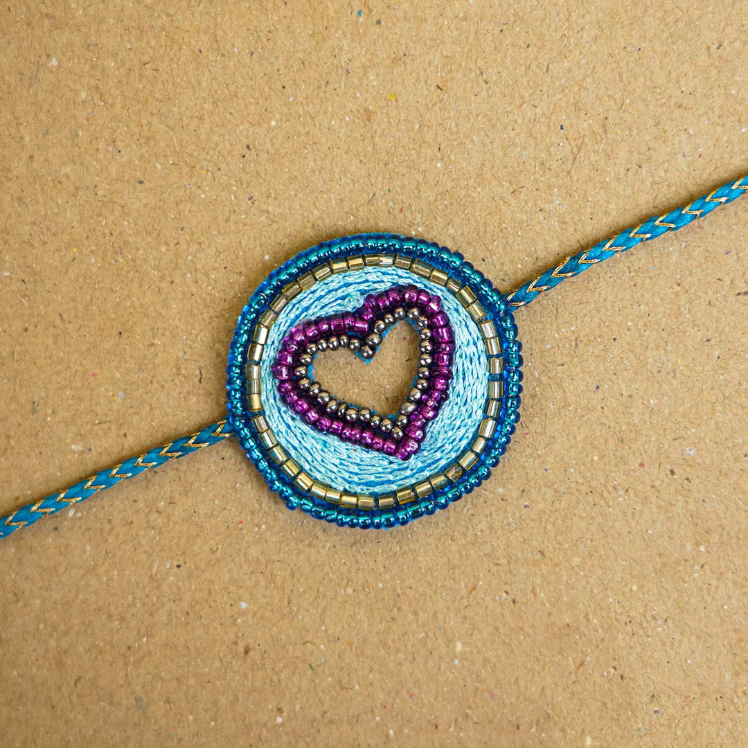 Handmade Beaded Heart Rakhi With Roli Chawal - Close-up of beaded bracelet