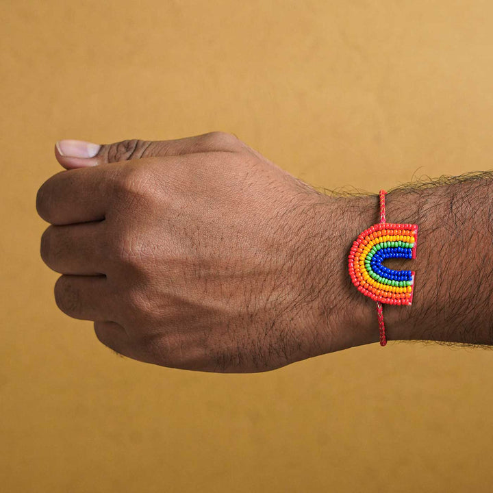 Handmade Beaded Rainbow Rakhi With Roli Chawal - Worn on Wrist Close-up