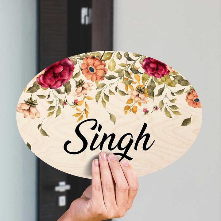 Printed Red And Orange Floral Wooden Oval Nameplate For Family - Name Personalization Example Held in Hand