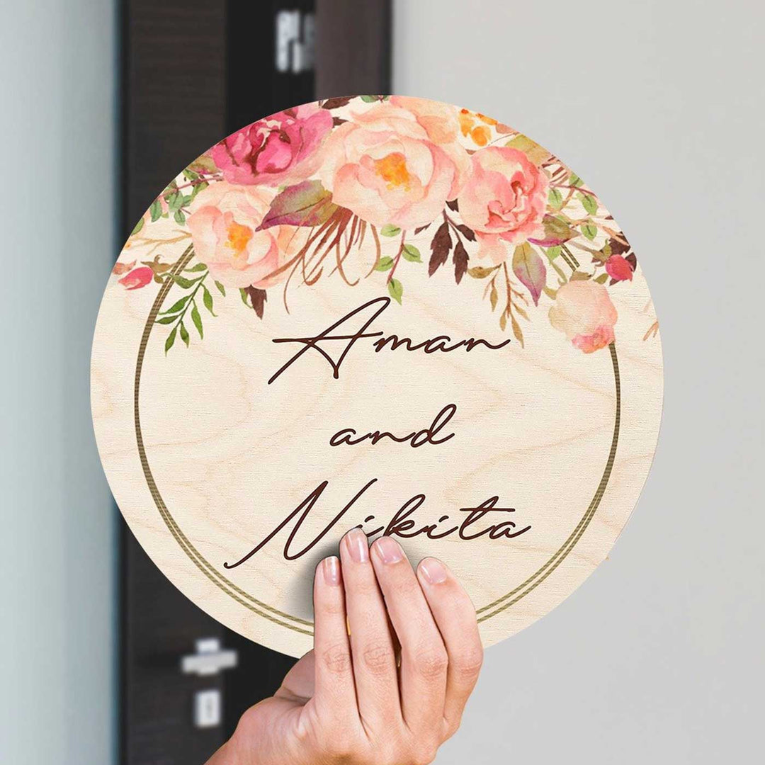 Printed Pink Floral Wooden Round Nameplate For Couples - Hand Held Front View Showing Personalization
