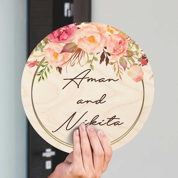 Printed Pink Floral Wooden Round Nameplate For Couples - Hand Held Front View Showing Personalization