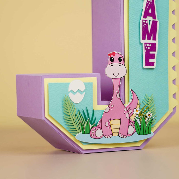Personalized Printed Dinosaur Theme For Girl Cardstock Monogram - Side View Showing Decoration Placement