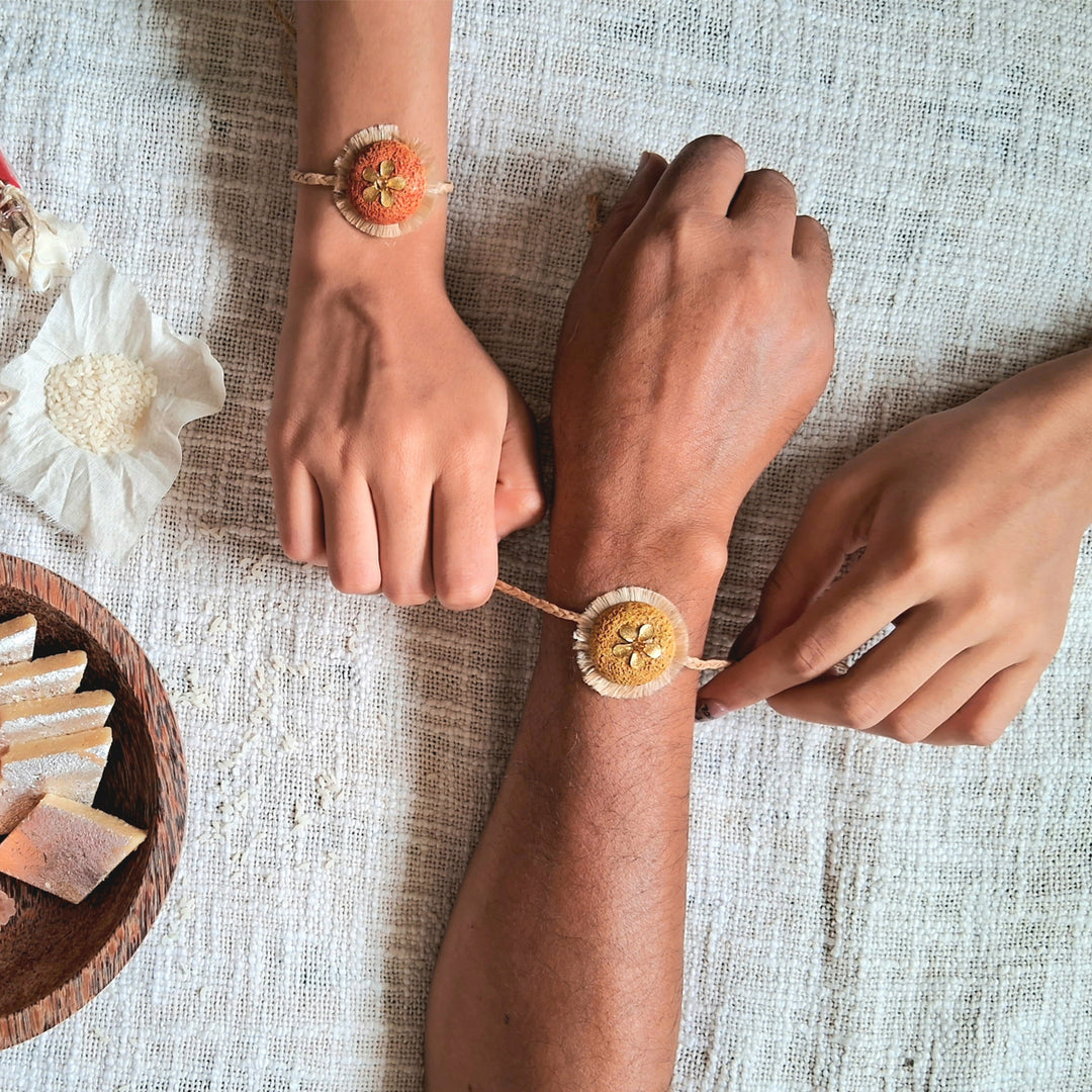 Handmade Papier Mache Antic Floral Rakhi With Roli Chawal Set Of 2 - Worn on wrists by models