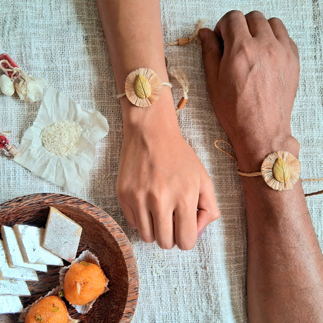 Handmade Papier Mache Yellow Leaf Rakhi With Roli Chawal - Worn Rakhi Pair on Wrists