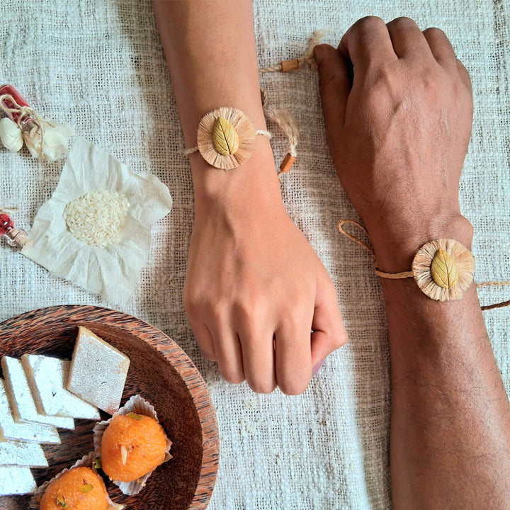 Handmade Papier Mache Yellow Leaf Rakhi With Roli Chawal - Worn Rakhi Pair on Wrists