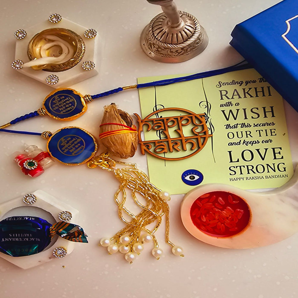 Handmade Gayatri Mantra Agate Bhaiya Bhabhi Rakhi With Roli Chawal - Flat lay with Rakhi set and greeting card