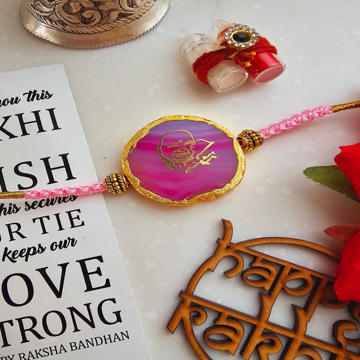 Handmade Shree Sai Baba Agate Rakhi With Roli Chawal For Brother - Close-up Front View Pink Rakhi