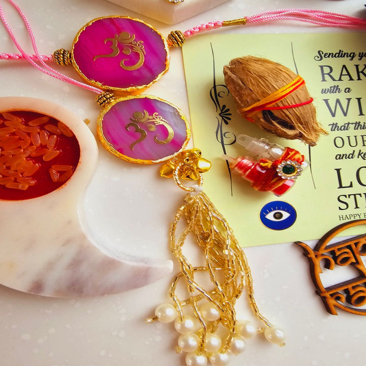 Handmade Om Agate Bhaiya Bhabhi Rakhi With Roli Chawal - Pink Rakhi Close-up with Decoration