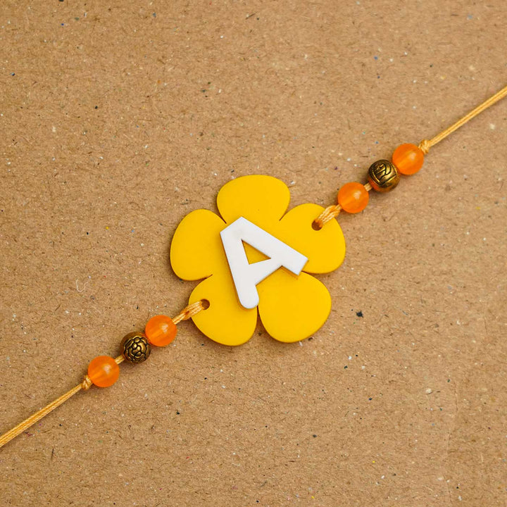 Personalized Handmade Alphabet Flower Acrylic Rakhi With Roli Chawal - Close-up of yellow bracelet detail