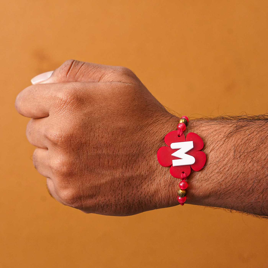Personalized Handmade Alphabet Flower Acrylic Rakhi With Roli Chawal - On wrist showing fit