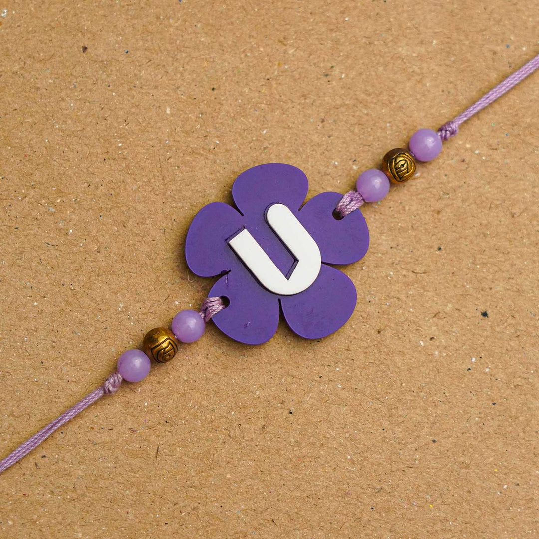 Personalized Handmade Alphabet Flower Acrylic Rakhi With Roli Chawal - Close-up of purple bracelet detail