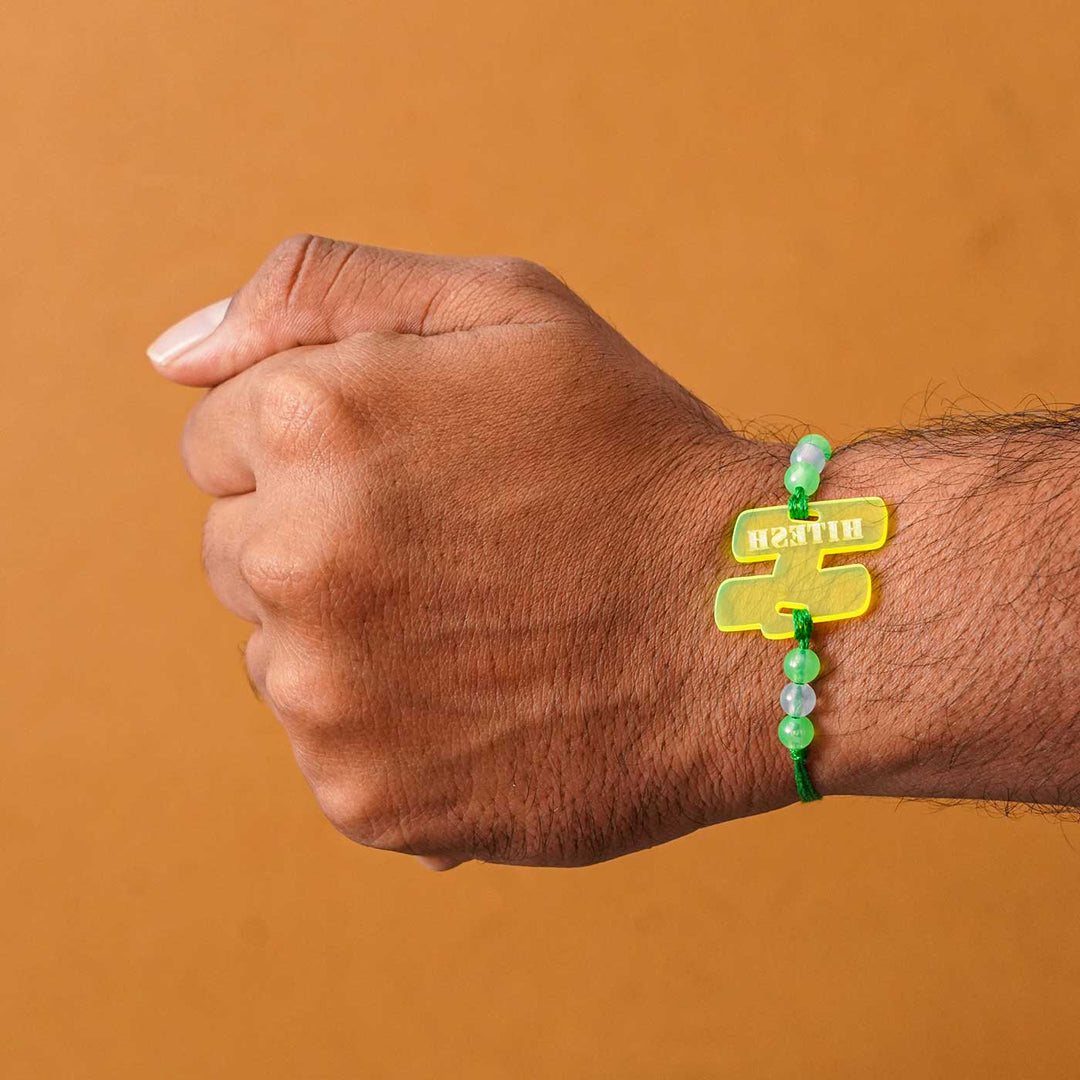 Personalized Handmade Alphabet Name Acrylic Rakhi With Roli Chawal - Green Rakhi Worn on Wrist