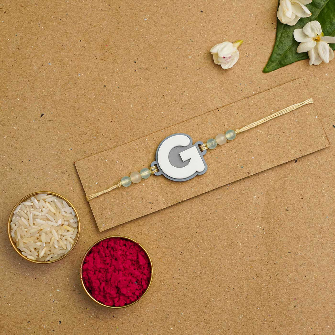 Personalized Handmade 3D Alphabet Acrylic Rakhi With Roli Chawal - Letter G Packaging Display