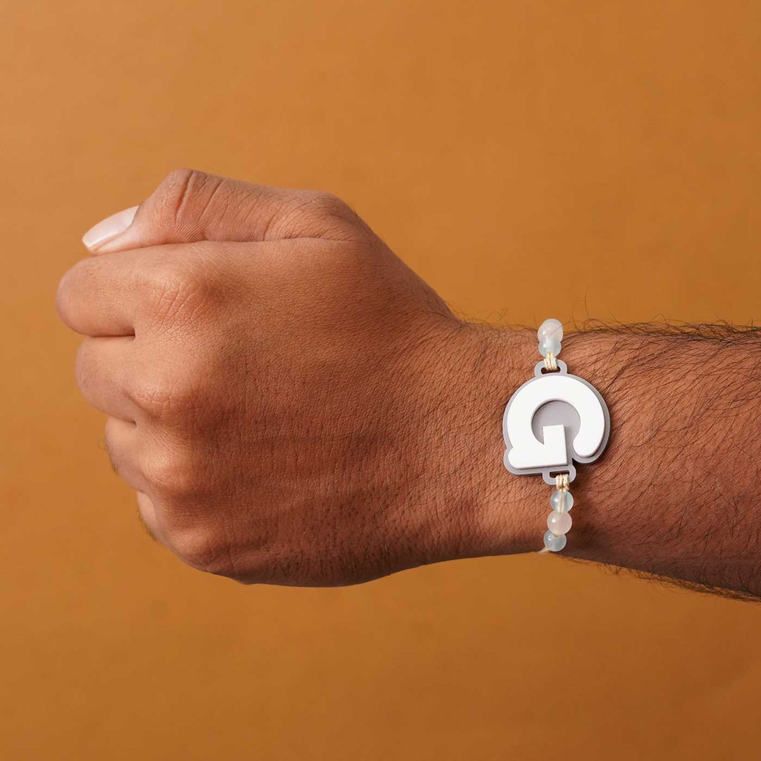 Personalized Handmade 3D Alphabet Acrylic Rakhi With Roli Chawal - Letter G Bracelet on Wrist