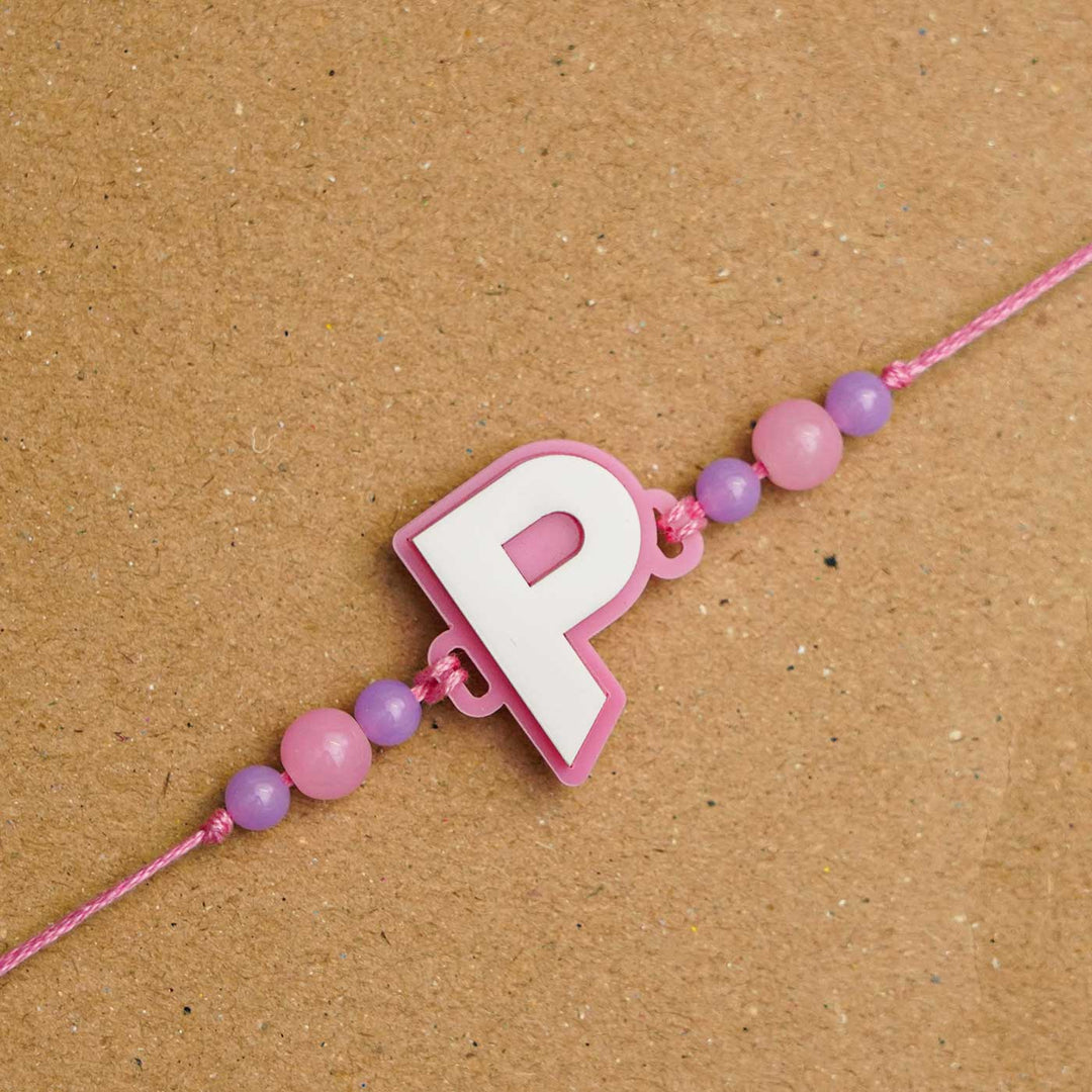 Personalized Handmade 3D Alphabet Acrylic Rakhi With Roli Chawal - Letter P Close-up on Surface