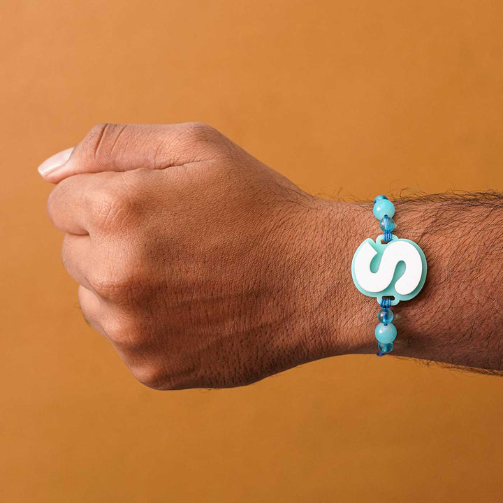 Personalized Handmade 3D Alphabet Acrylic Rakhi With Roli Chawal - Letter S Bracelet on Wrist