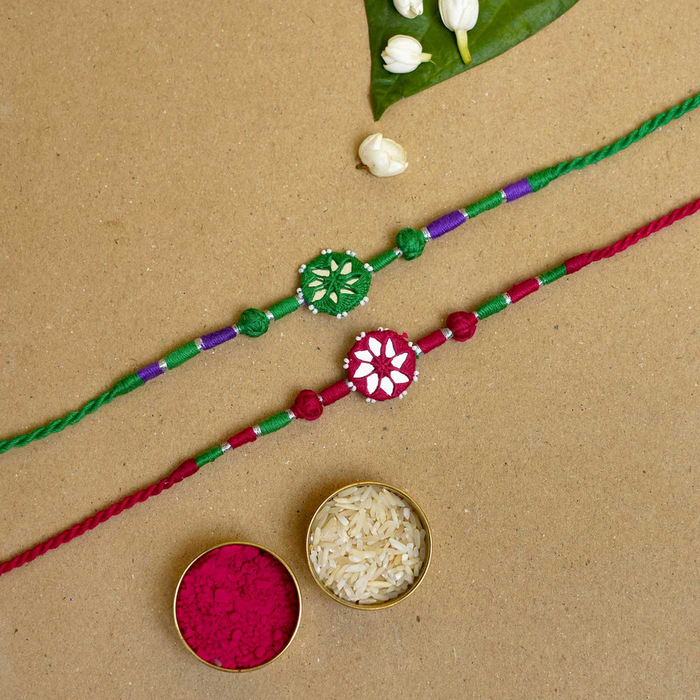 Handmade Mirror Work Patwa Maroon Green Cotton Rakhi With Roli Chawal Set Of 2 - Rakhis with traditional rice and kumkum