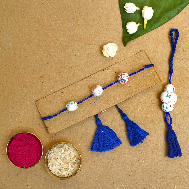 Handmade Shweth Potli Upcycled Fabric Bhaiya Bhabhi Rakhi With Roli Chawal Set Of 2 - Rakhi with rice and color powder