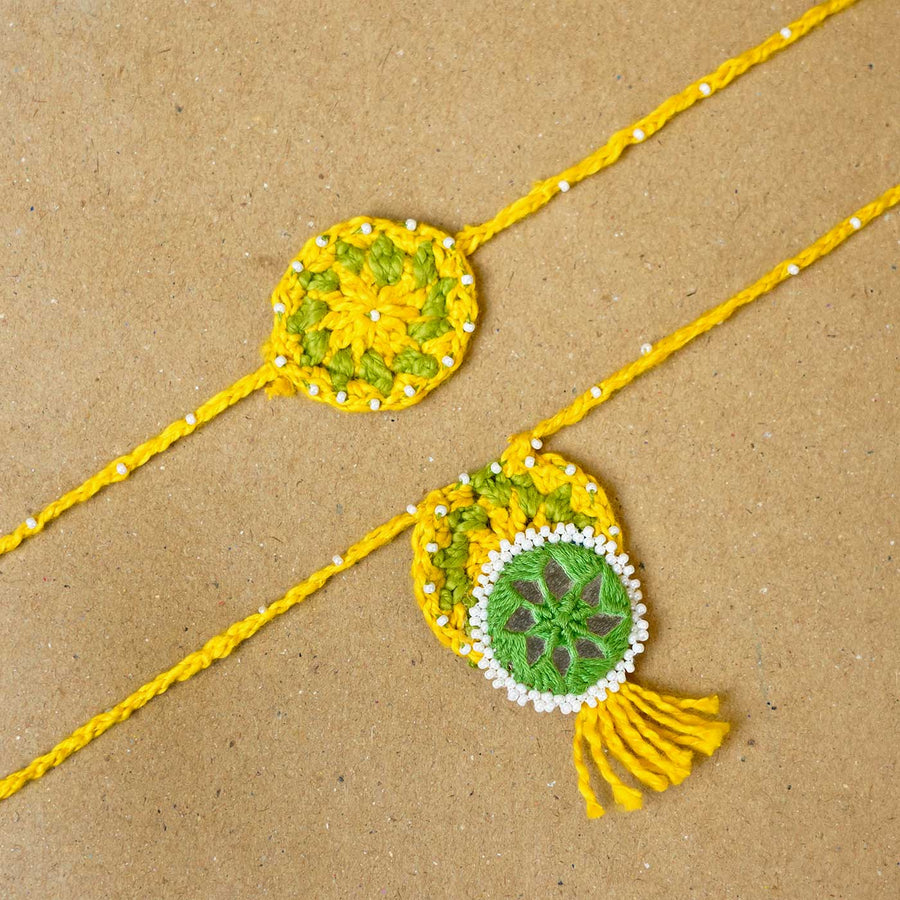 Handmade Crochet Mirror Blossom Bhaiya Bhabhi Rakhi With Roli Chawal Set Of 2 - Close-up of Crochet Rakhi Pair