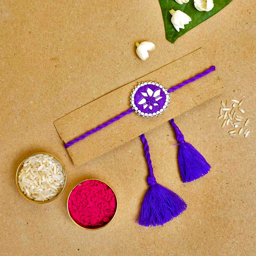Handmade Mirror Work Kajal Purple Rakhi With Roli Chawal - Packaged rakhi with traditional items