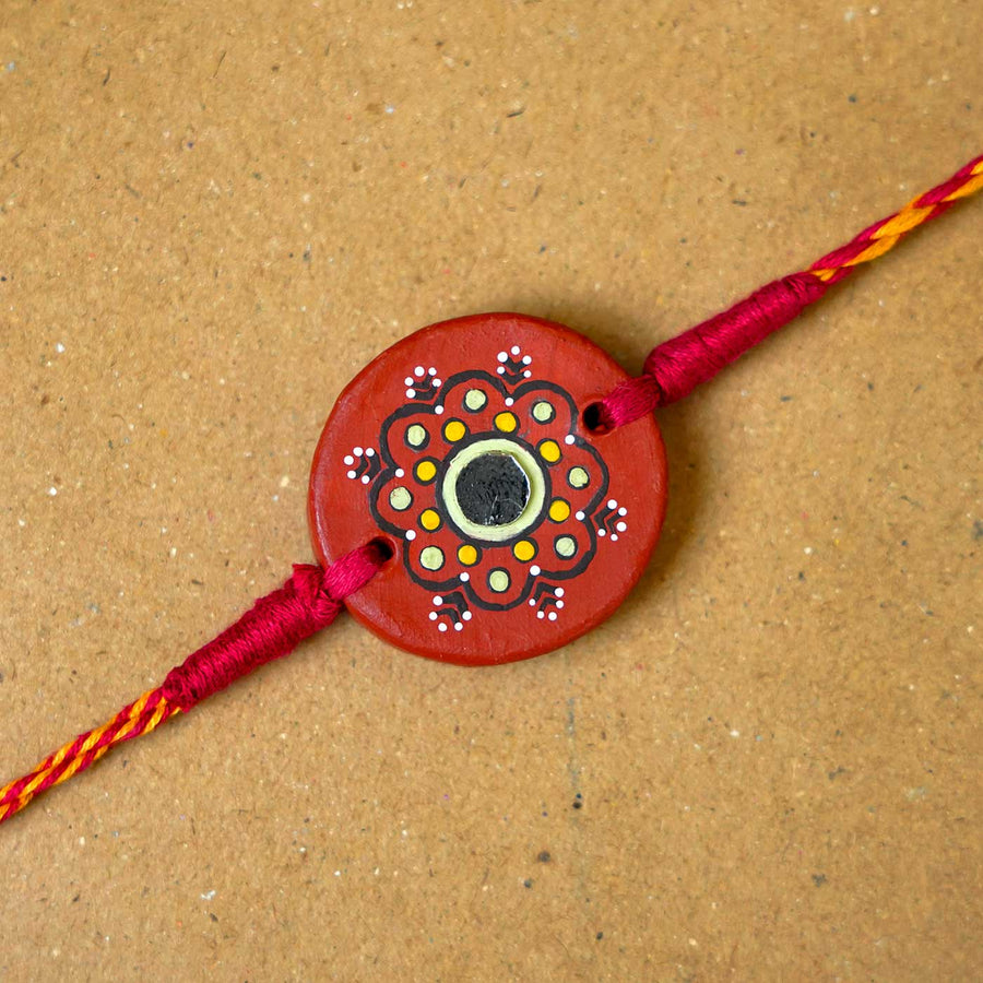 Hand Painted Dharti Terracotta Rakhi With Roli Chawal - Close-up of Rakhi centerpiece
