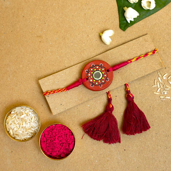 Hand Painted Dharti Terracotta Rakhi With Roli Chawal - Rakhi on card with traditional items