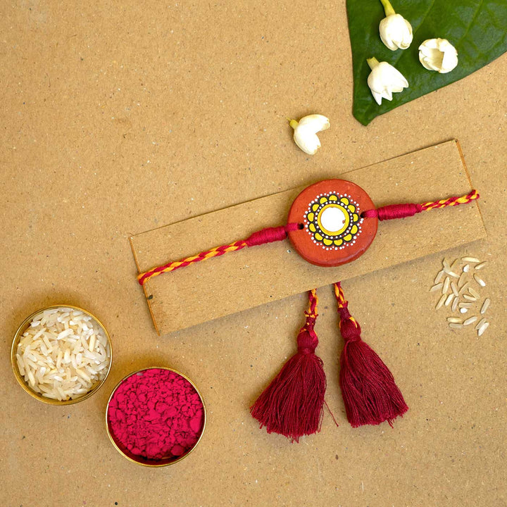 Hand Painted Suraj Terracotta Rakhi With Roli Chawal - Rakhi on display card