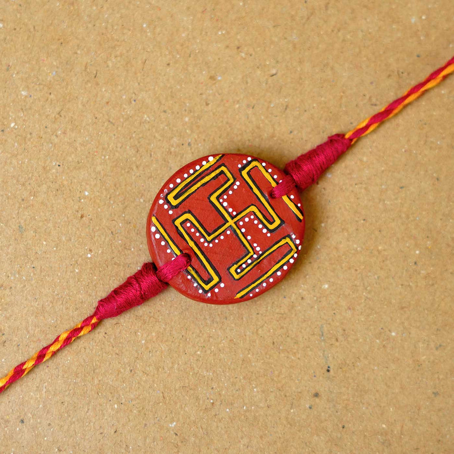 Hand Painted Swastik Terracotta Rakhi With Roli Chawal - Close-up of Rakhi Centerpiece