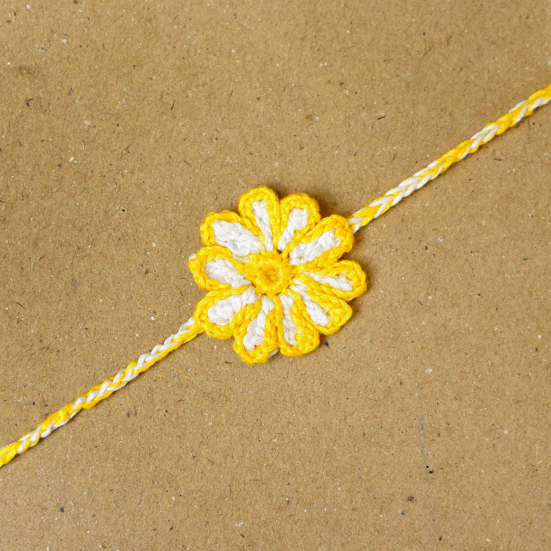 Handmade Crochet Sunflower Rakhi With Roli Chawal - Close-up of single floral rakhi