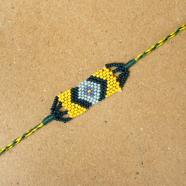 Handmade Beaded Traditional Grace Rakhi With Roli Chawal - Close-up of Yellow Beaded Rakhi