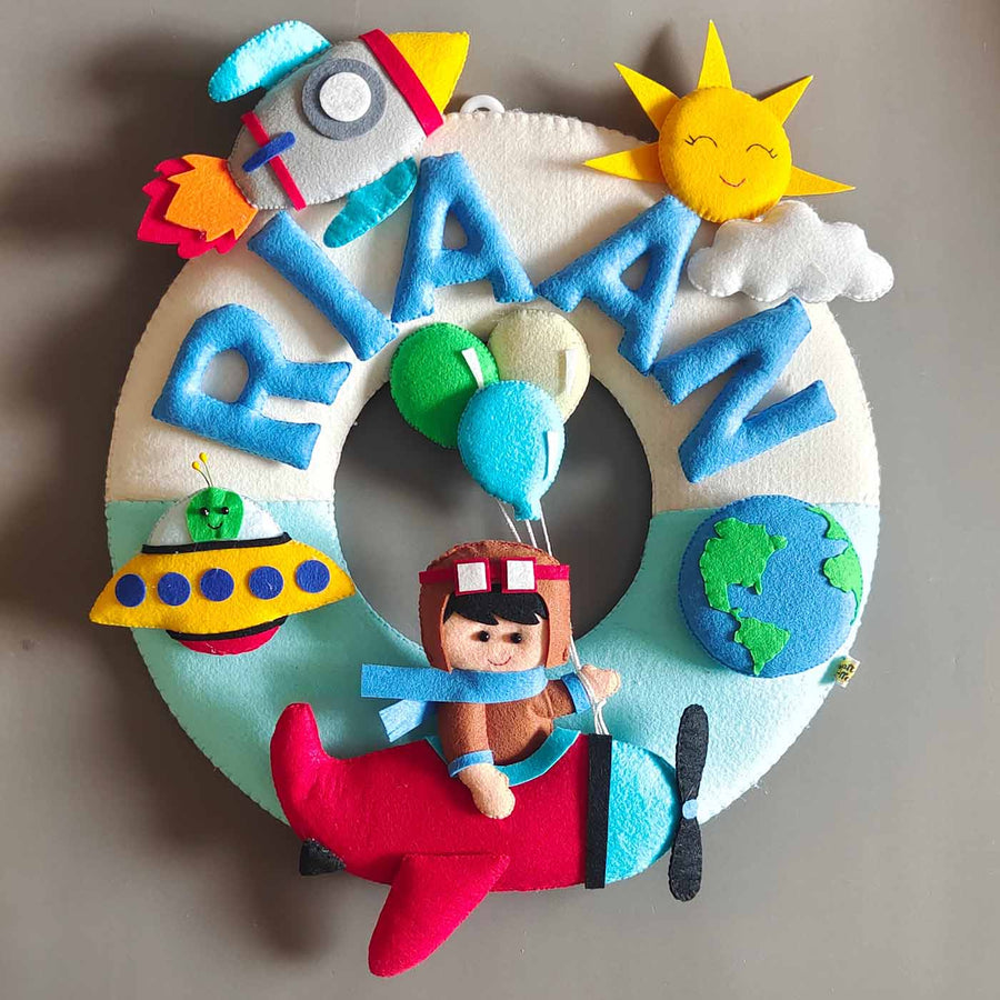 Hand Stitched Space Themed Round Felt Kids Name Plate - Front View Hanging on Wall