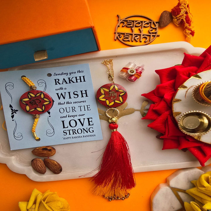 Handmade Laser Cut Red Om Ceramic Bhaiya Bhabhi Rakhi With Roli Chawal - Rakhi with Wish Card Display