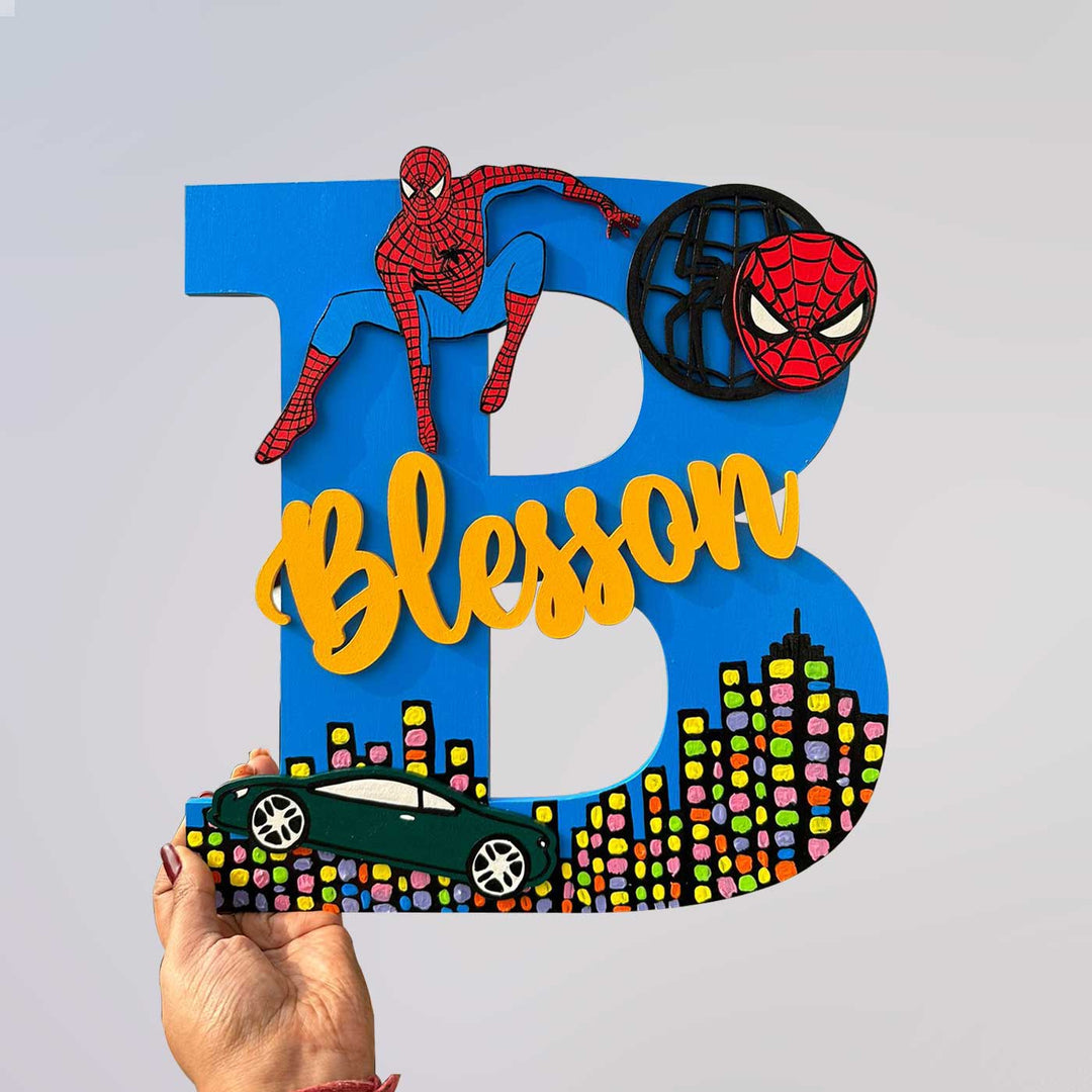 Hand Painted Personalised Kids Spiderman Themed Monogram Name Plate 1 - Front View with Hand Holding