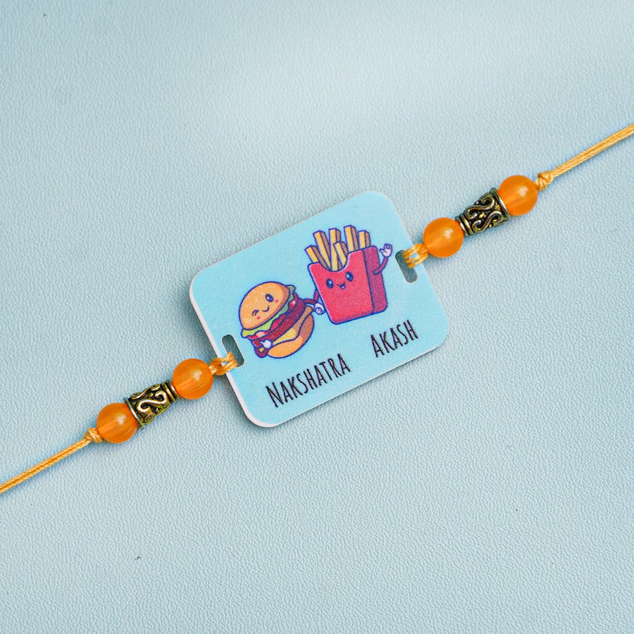 Personalized Handmade Burger And Fries Acrylic Kids Rakhi With Roli Chawal - Close-up of Rakhi with Names