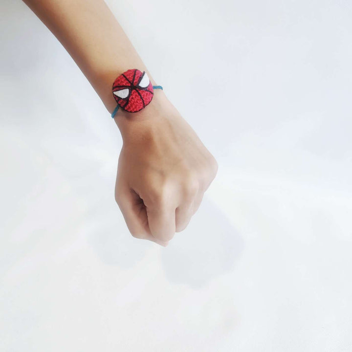 Handmade Crochet Spiderman Kids Rakhi With Roli Chawal - On Wrist Model