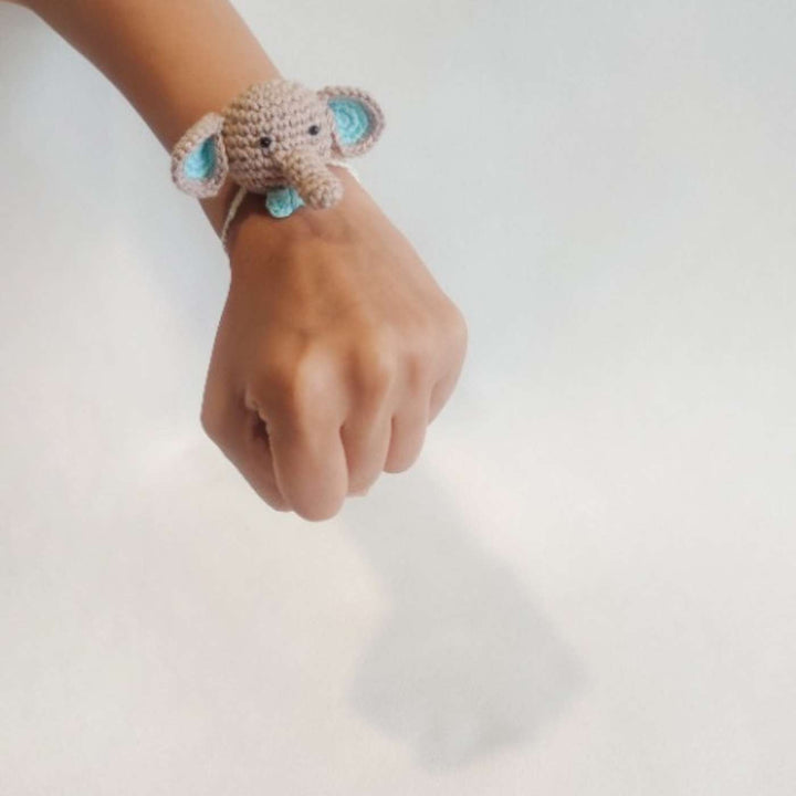 Handmade Crochet Dumbo Kids Rakhi With Roli Chawal - Wrist Model Wearing Bracelet