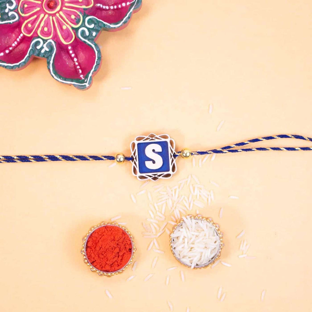 Personalized Handmade Name Initials Wooden Rakhi With Roli Chawal - Top View with Pooja Items