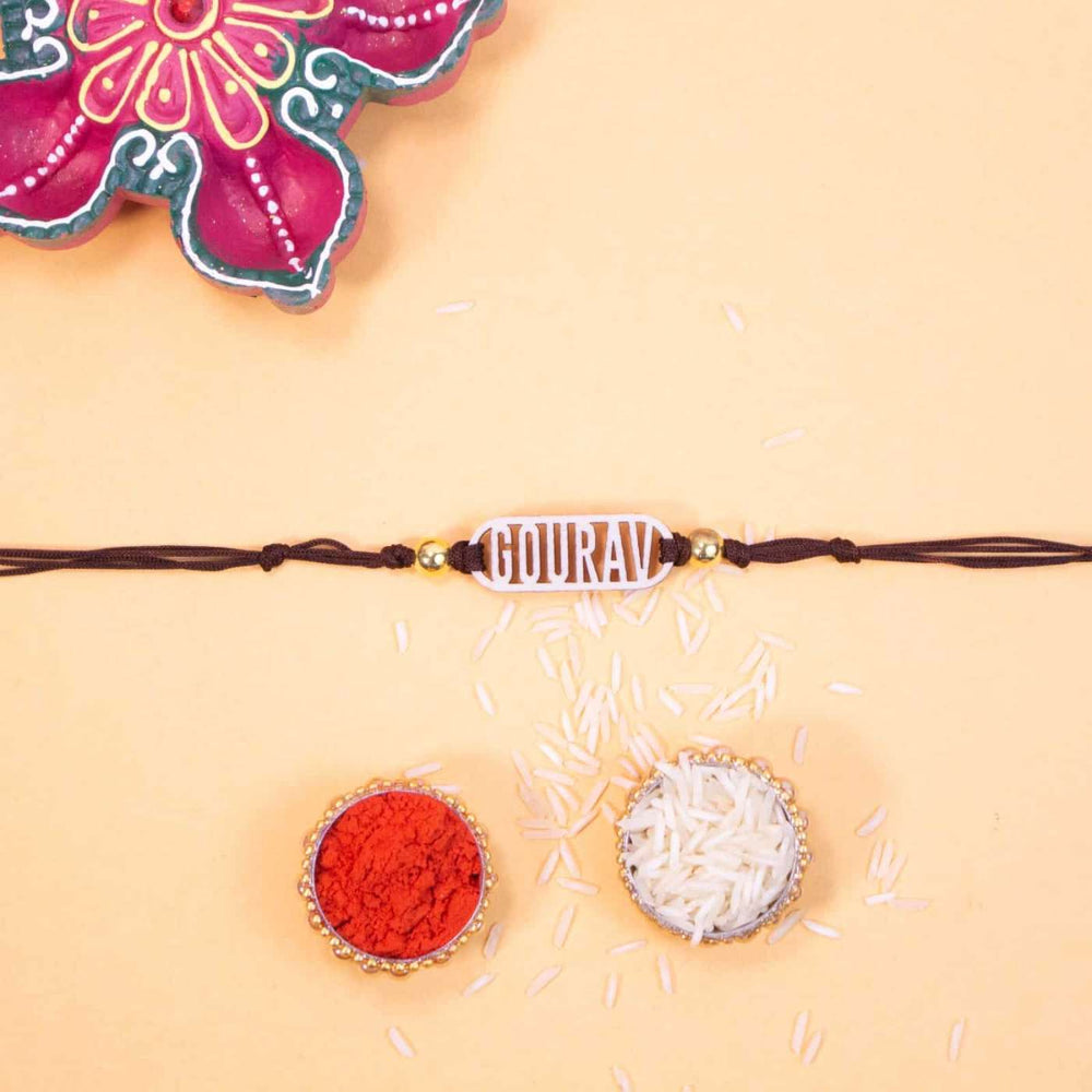 Personalized Handmade Classic Wooden Rakhi With Roli Chawal - Flat lay with traditional thali items