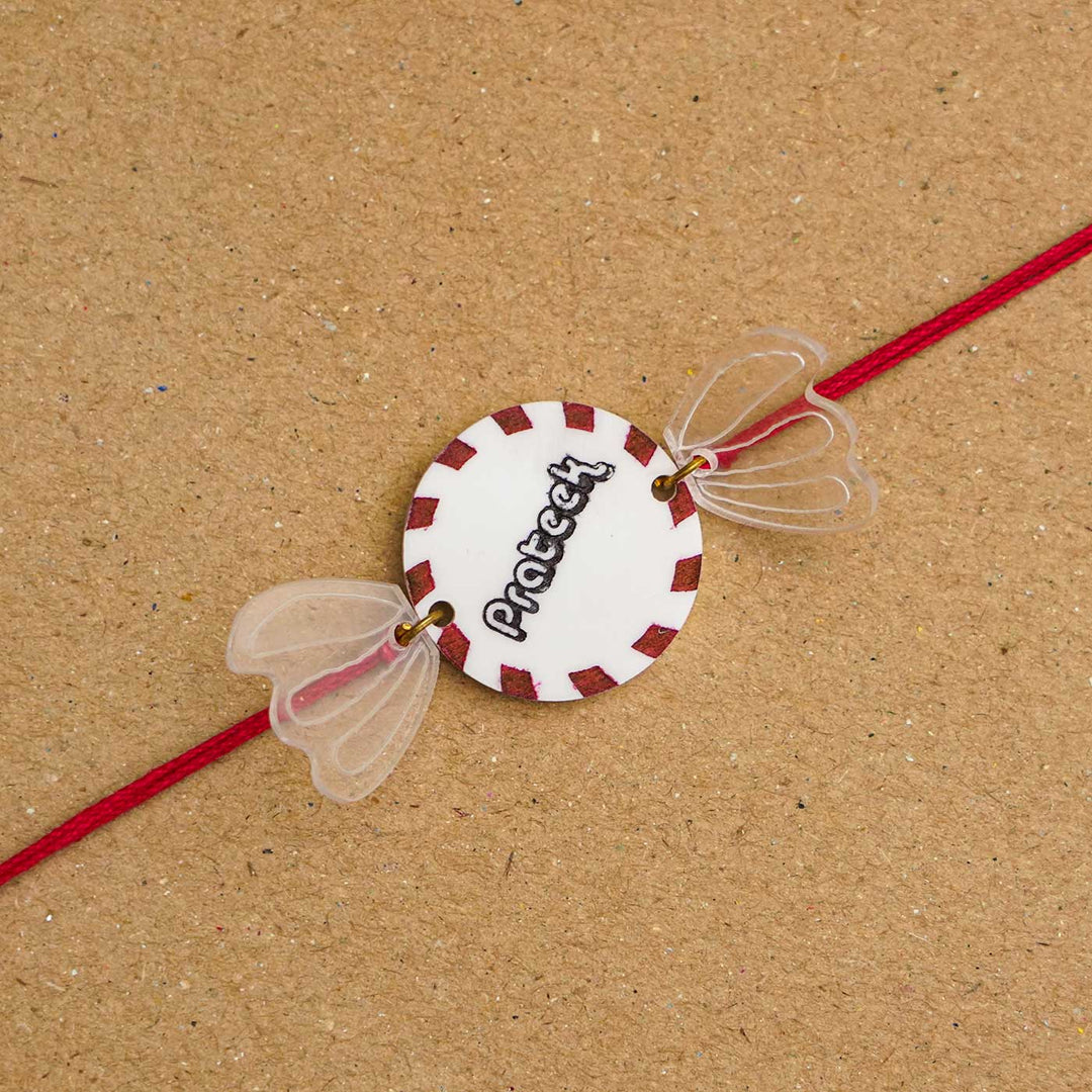 Personalized Handmade Chocolate Acrylic Kids Rakhi With Roli Chawal - Close-up of alternate text design
