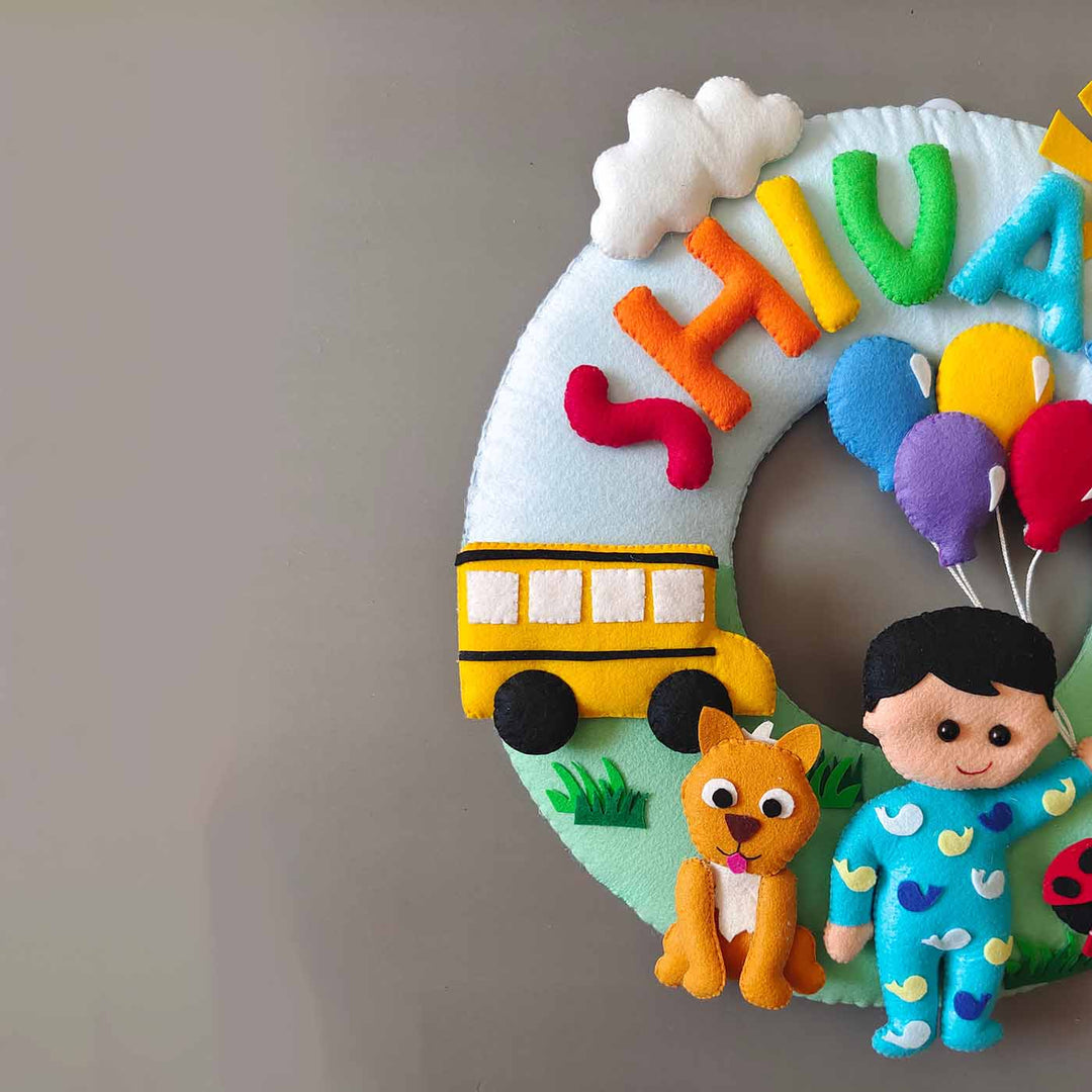 Hand Stitched Cocomelon Themed Round Felt Kids Name Plate For Baby Boy - Partial Front View with Name Personalization
