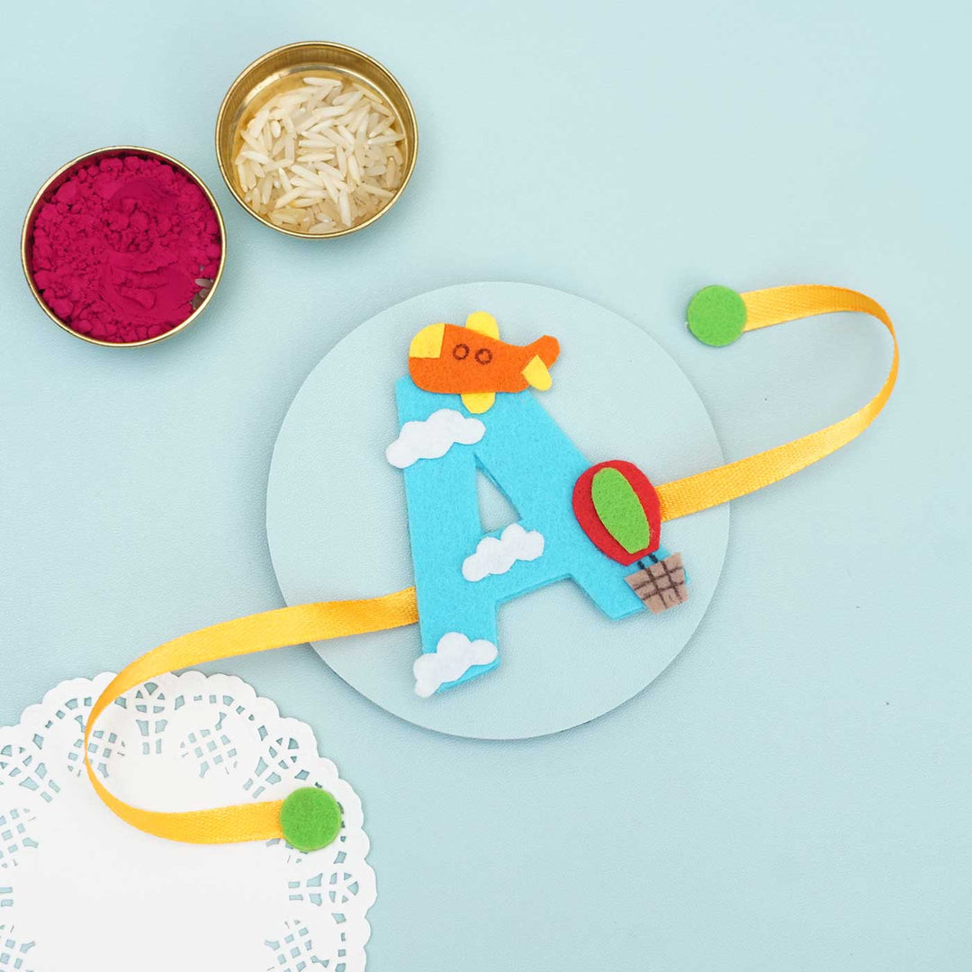 Personalised Handmade Hot Air Ballon Felt Rakhi With Chocolates Roli Chawal - Ribbon Laid Flat with Accessories