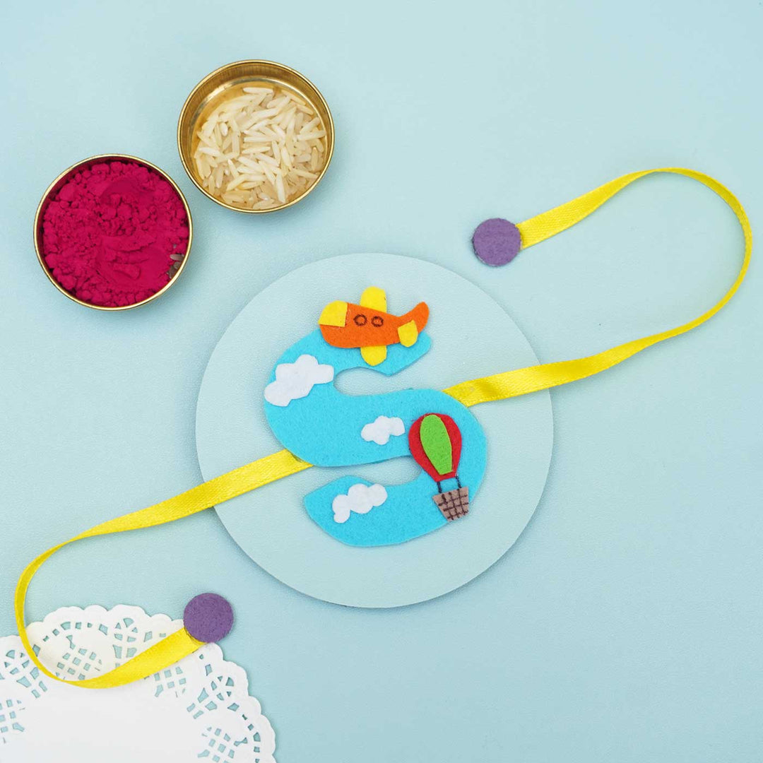 Personalised Handmade Hot Air Ballon Felt Rakhi With Chocolates Roli Chawal - Ribbon Laid Flat with Accessories (5)