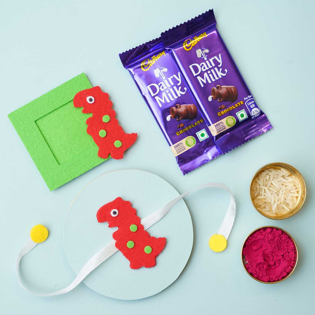 Handmade Red Dinosaur Felt Rakhi Photoframe Magnet With Chocolates Roli Chawal - Product with Rakhi Essentials