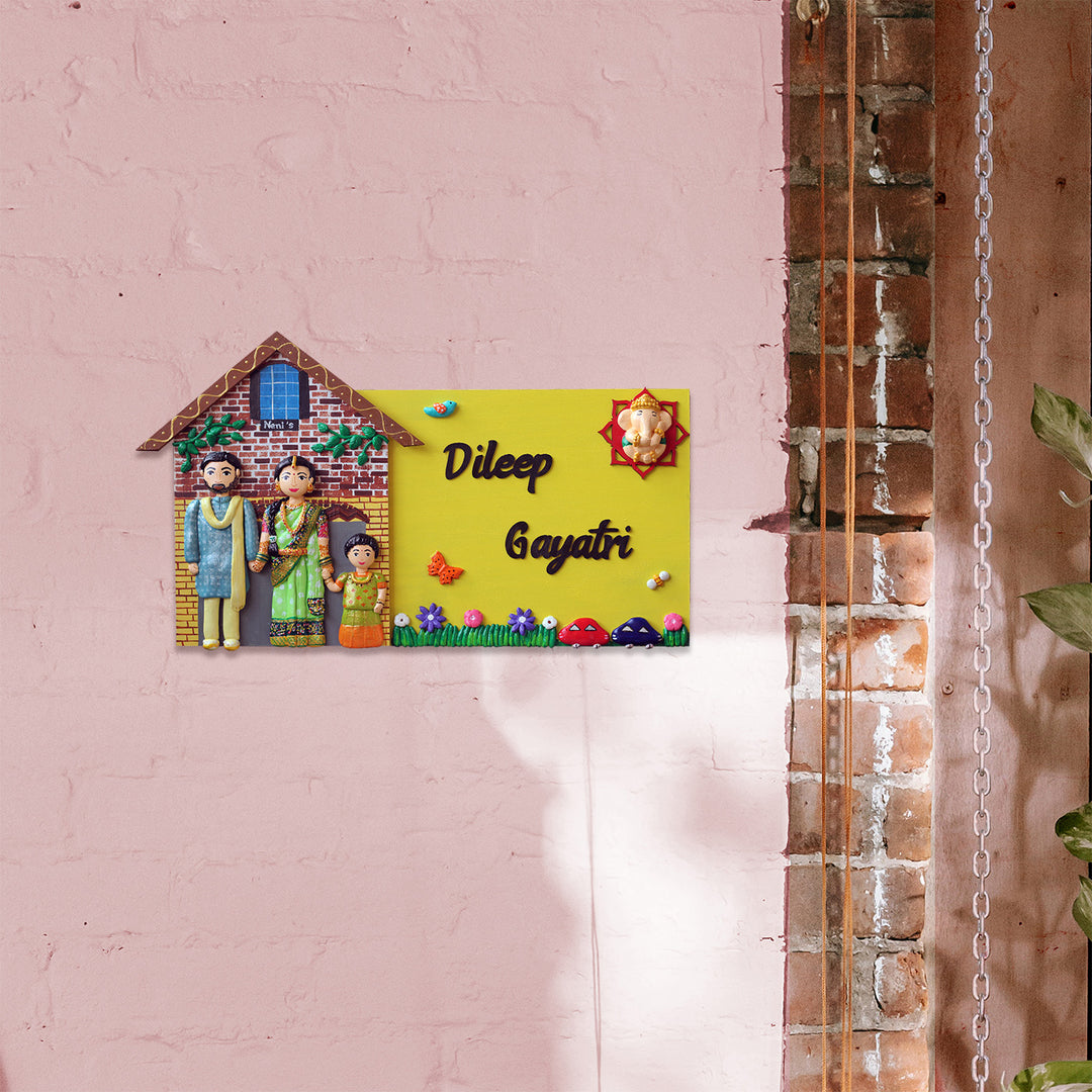 Handcrafted Personalized Hut Shaped Family Name Plate - Mounted on Pink Wall Side View