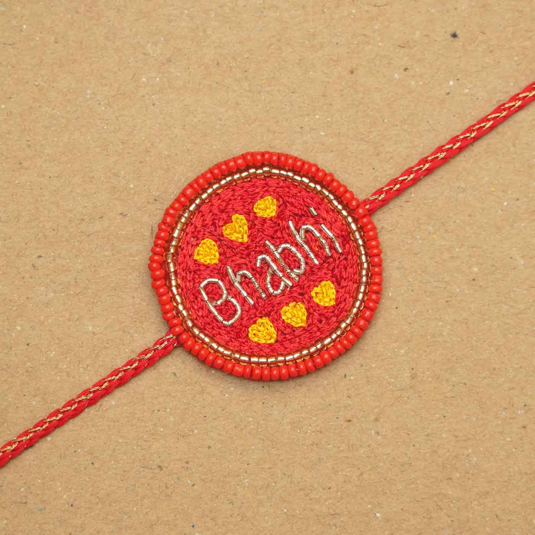 Handmade Beaded Bhabhi Rakhi With Roli Chawal - Flat Lay Close-up View